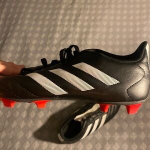 Adidas Black Cleats with White Stripes and Red Soles